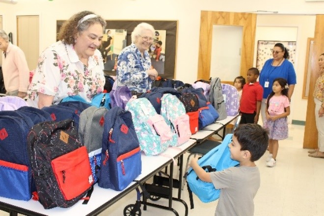 Seniors work at backpack drive